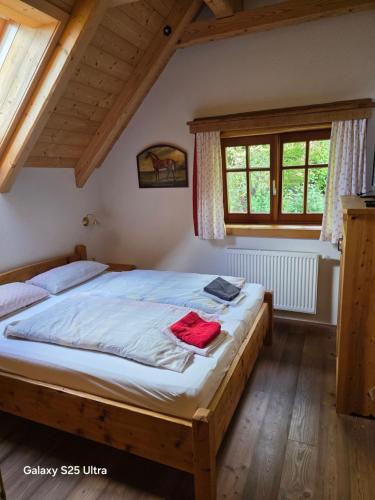 a bedroom with a large bed in a attic at Waldheimathütten in Sankt Kathrein am Hauenstein