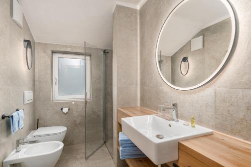 a bathroom with a sink and a mirror at Residence Diana Apartment 303 in Terento