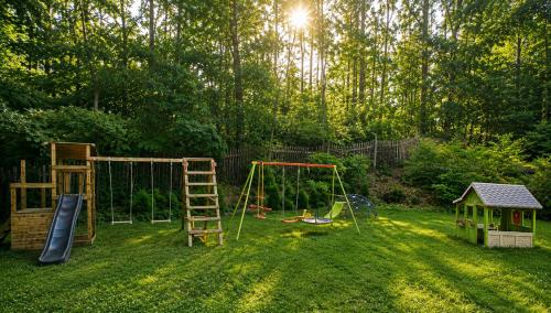 a yard with a playground with a ladder and a swing at Parkhotel Zirndorf in Zirndorf