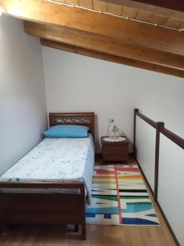 a bedroom with a bed and a wooden ceiling at Casa Evelina in Villanovotulo