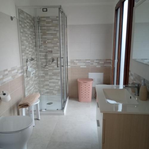 a bathroom with a shower and a toilet and a sink at Casa Evelina in Villanovotulo