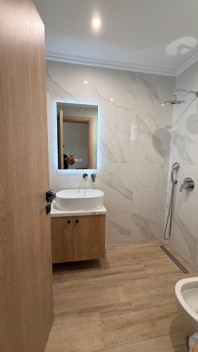 a bathroom with a sink and a mirror at Sabbia Suites in Nea Vrasna