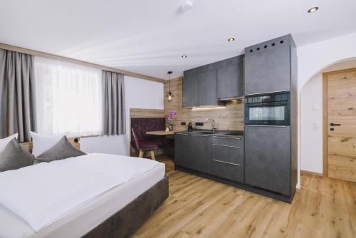 a hotel room with a bed and a kitchen at Haus Martinus in Mayrhofen