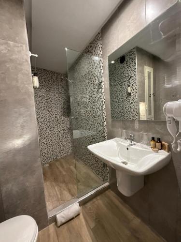 a bathroom with a sink and a shower at Hamilton Suites & Appart in Casablanca