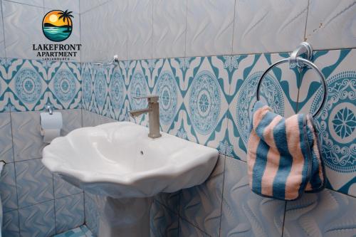 a bathroom with a sink and a towel at Lake Front Apartment in Georgetown