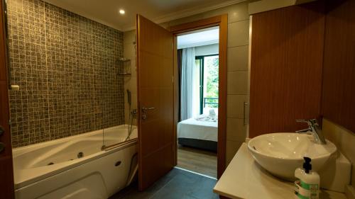 a bathroom with a sink and a bath tub and a sink at Villa Diva in Kemer