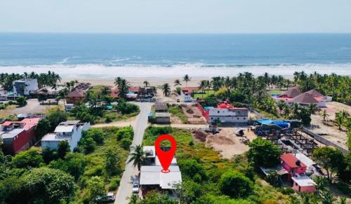 an aerial view of a resort with a red marker at Casa De Playa in Agua de Correa