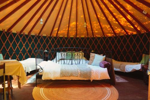 a room with a bed in a yurt at Yurtcamp Devon in Heathfield
