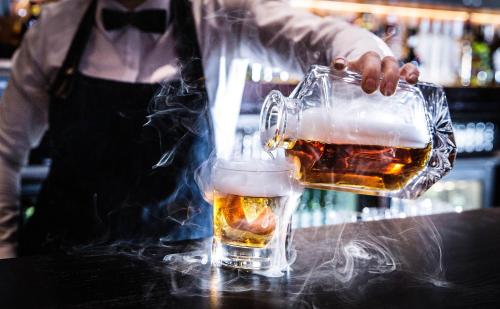a bartender is serving two glasses of beer at Malmaison Edinburgh in Edinburgh