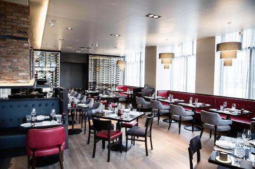 a restaurant with tables and chairs and a bar at Malmaison Edinburgh in Edinburgh
