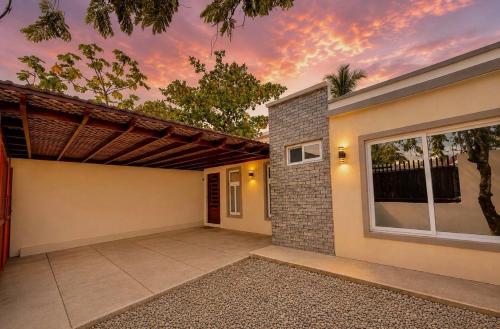 a house with a garage with a sunset at Nandos Places in Puerto Barrios