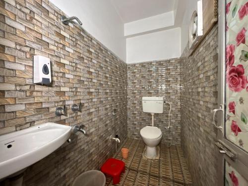 a bathroom with a sink and a toilet and a tub at Hotel Radiation Deoghar in Deoghar