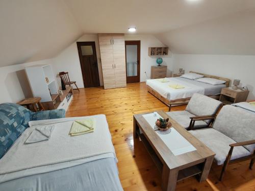 a living room with two beds and a table at Dedinje, ul Zorana Mitrovića 22 in Jagodina