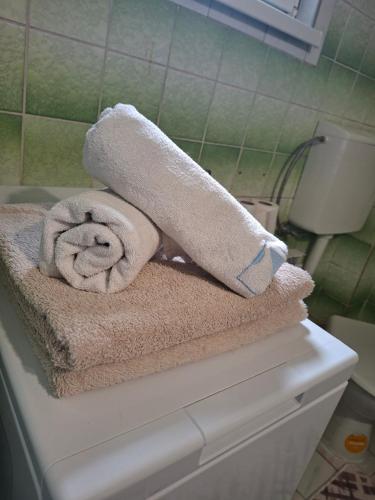 a pile of towels sitting on top of a bathroom at Apartman Mickey in Sarajevo