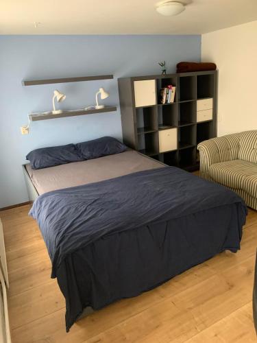 a bedroom with a bed and a couch at Althuizenhof - Jelle in Doenrade