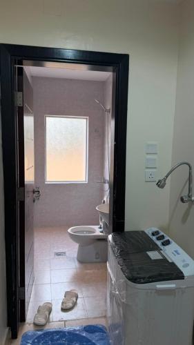 a bathroom with a shower and a toilet and a sink at فيولورين سويتس in Al Baha