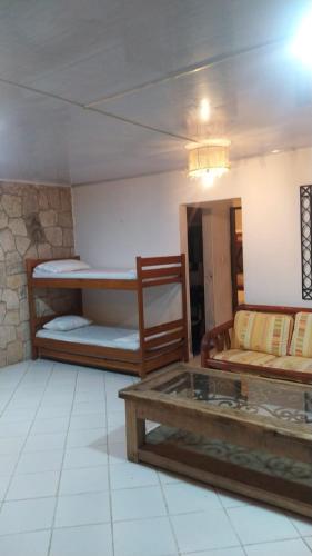 a room with two bunk beds and a table at Palma Paraíso Hotel in Melgar