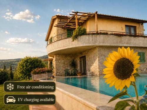 a house with a sunflower next to a swimming pool at Villa Vale in Casole dʼElsa