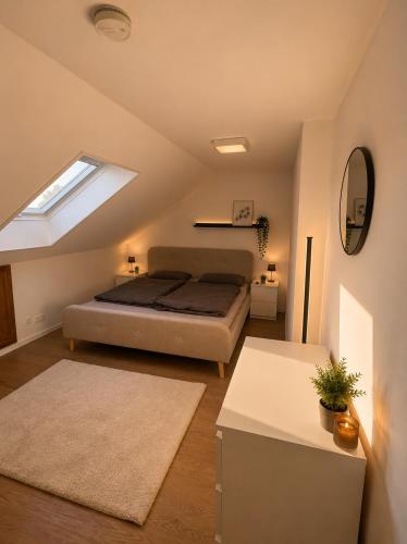 a bedroom with a bed and a skylight at Moderne Dachgeschosswohnung in Kirchlengern