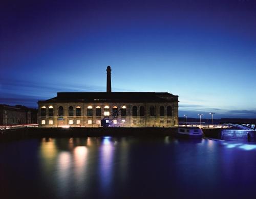 a building with a cross on top of it at night at Royal William Yard Apartment in Plymouth