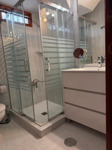 a bathroom with a shower and a toilet and a sink at Villa Buendía in Puerto del Carmen