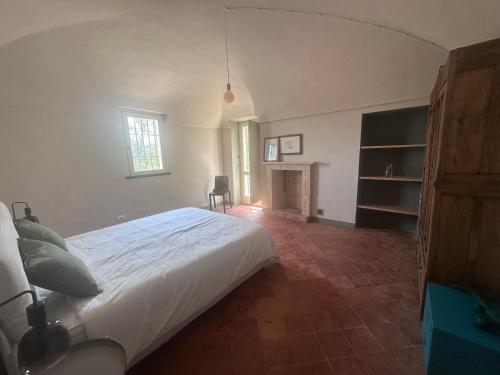 a bedroom with a large bed and a fireplace at Casia Vacanze con due appartamenti in Bene Vagienna