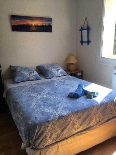 a bedroom with a bed with a blue comforter at L'Hysope Gap, Maison d'hôtes contemporaine avec vue in Gap