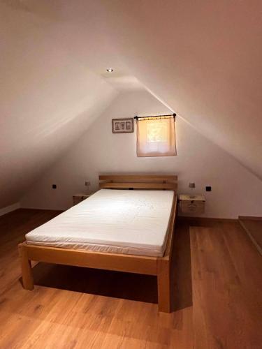 a bedroom with a bed in the attic at Ranč na hribu in Trebnje