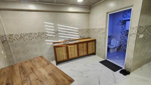a bathroom with a sink and a toilet at Modern Palace Dawassah in Al Mawşil