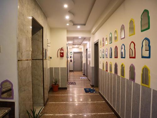 a hallway in a hospital with colorful walls at Jungle by sturmfrei Agra in Agra