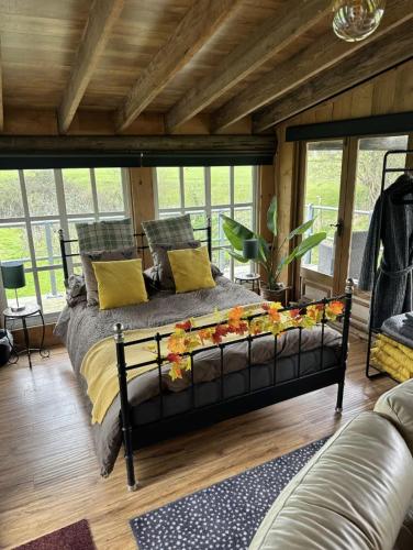 a bedroom with a bed with flowers on it at Scarthingmoor Lodges in Weston