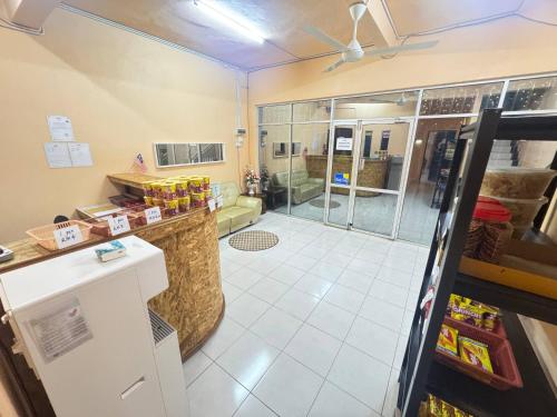 a bathroom with a shower with a glass door at Hotel RS Inn in Rantau Panjang