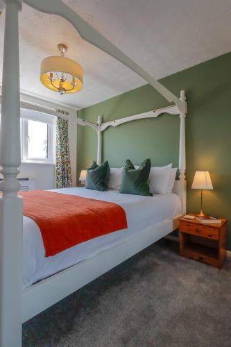 a bedroom with a white bed with a red blanket at Stylish Cheshire House in Winsford