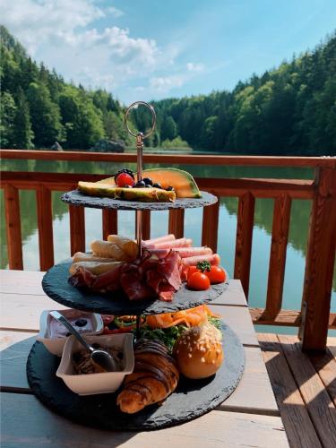 a three tiered tray of food on a table with a table gmaxwell gmaxwell gmaxwell at Berglsteinersee 712er Lounge in Breitenbach am Inn