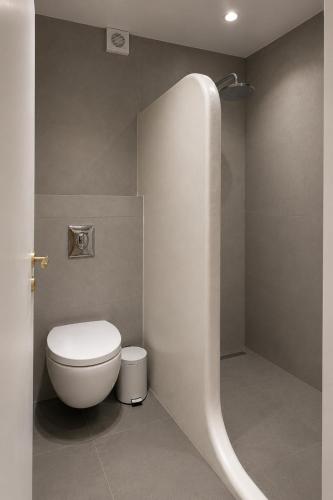 a bathroom with a toilet and a shower at Orama Suite II Mykonos Sunset & Pool in Mikonos