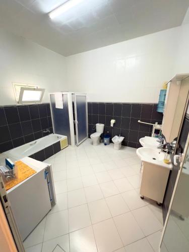 a large bathroom with two toilets and a sink at Villa Yassir expert Cabo in Cabo Negro