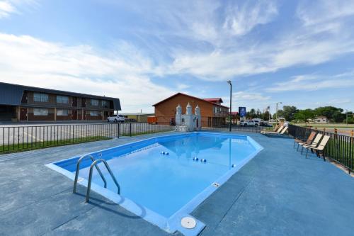 a large swimming pool in front of a building at Americas Best Value Inn Wall in Wall