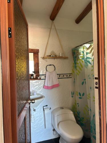 a bathroom with a toilet and a sink at Cosy Private Room In A Community Home - A Space To Remember You In Andean Mountains in Pisac