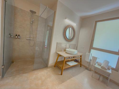 a bathroom with a shower and a sink and a mirror at Riad Timija in Marrakesh