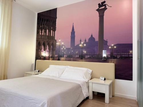 a bedroom with a bed with a view of a city at Hotel Angi in Fossò