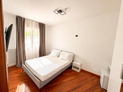 a bedroom with a white bed and a window at Del Console Apartment 2 - Near Bari Airport & Station in Modugno