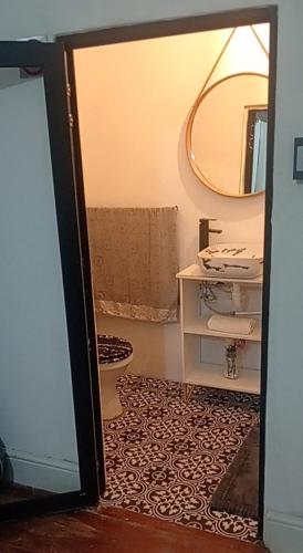 a bathroom with a sink and a toilet and a mirror at M Group B&B in King Williamʼs Town