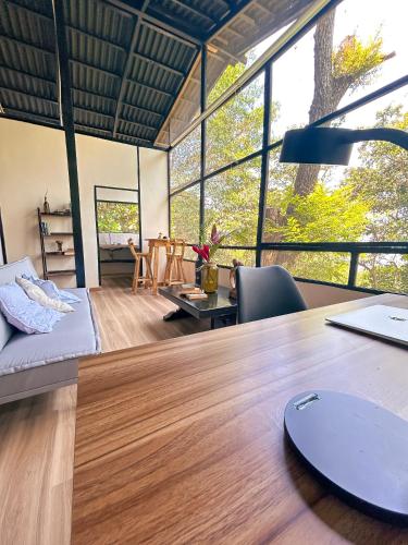 an office with a desk and a large window at Minca Ecohabs Hotel in Minca