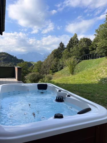 a hot tub with a view of a hill at Agriturismo Saettà in Lentiai