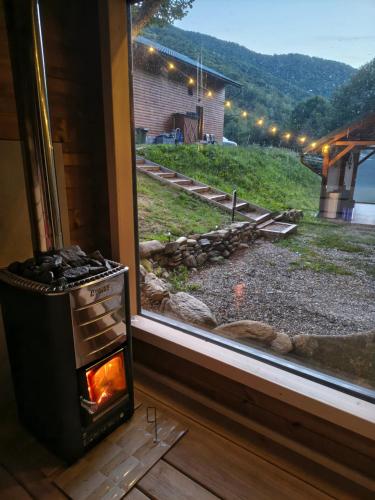 a stove sitting next to a window with a view at Cabana pe Vale in Marga