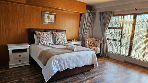 a bedroom with a large bed and a window at Grobler's Haven On Vaal - Barrage in Tumahole