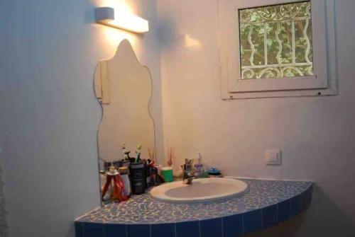 a bathroom with a sink and a mirror at Villa Reine Saly in Saly Portudal