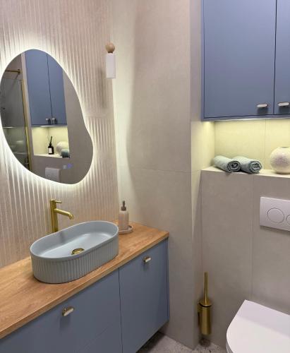 a bathroom with a sink and a mirror at Apartament Lake Mood Iława in Iława