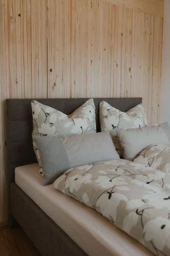 a bed with white pillows on top of it at Natururlaub by Klotz TINY HAUS d in Überlingen