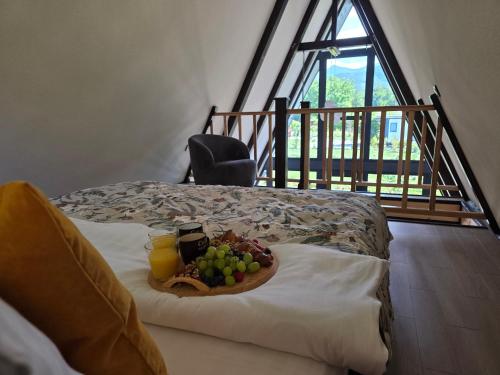 a tray of fruit on a bed in a room at Api Chalet in Avrig